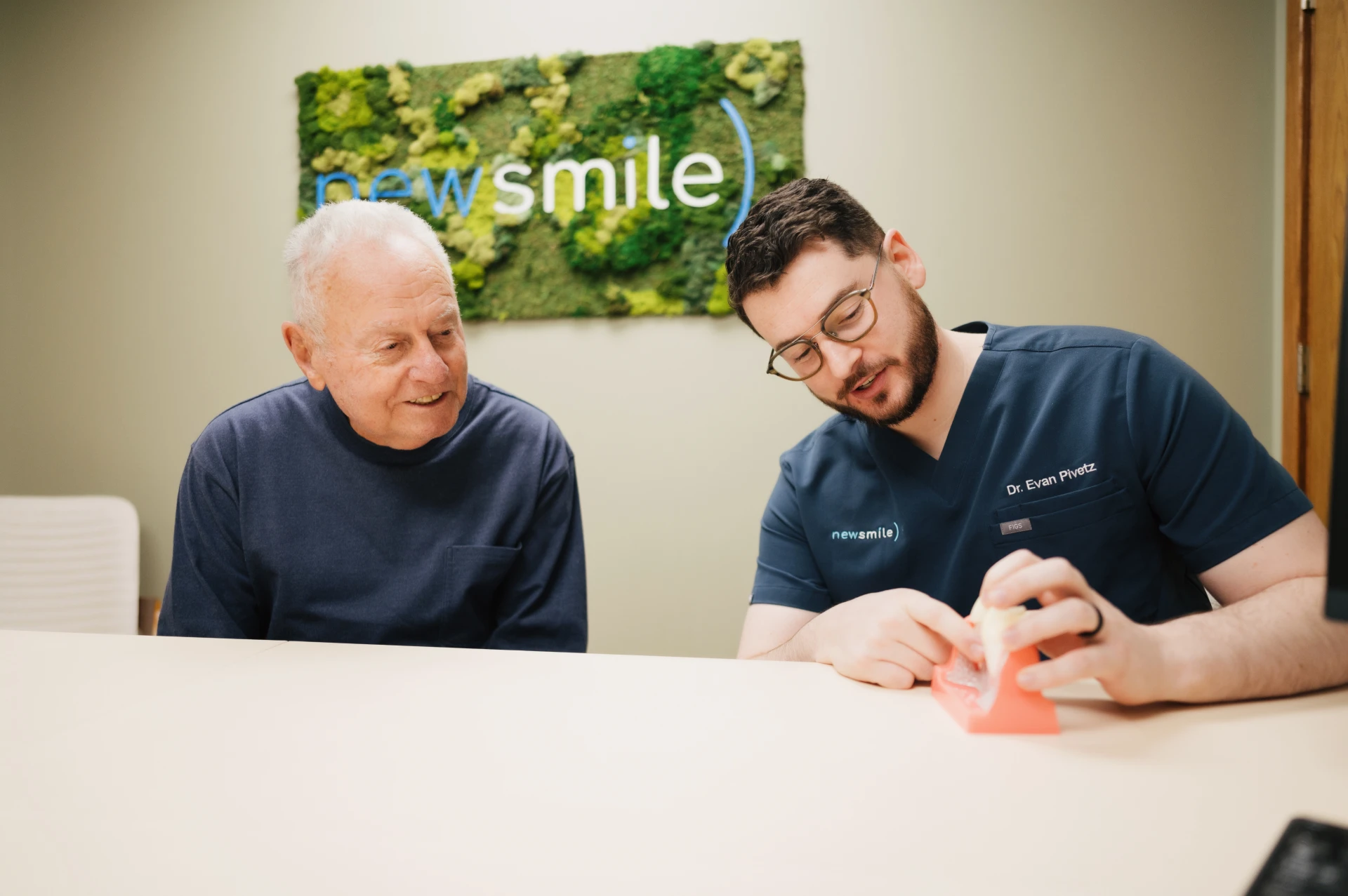 Doctor explaining what are full mouth dental implants to a patient