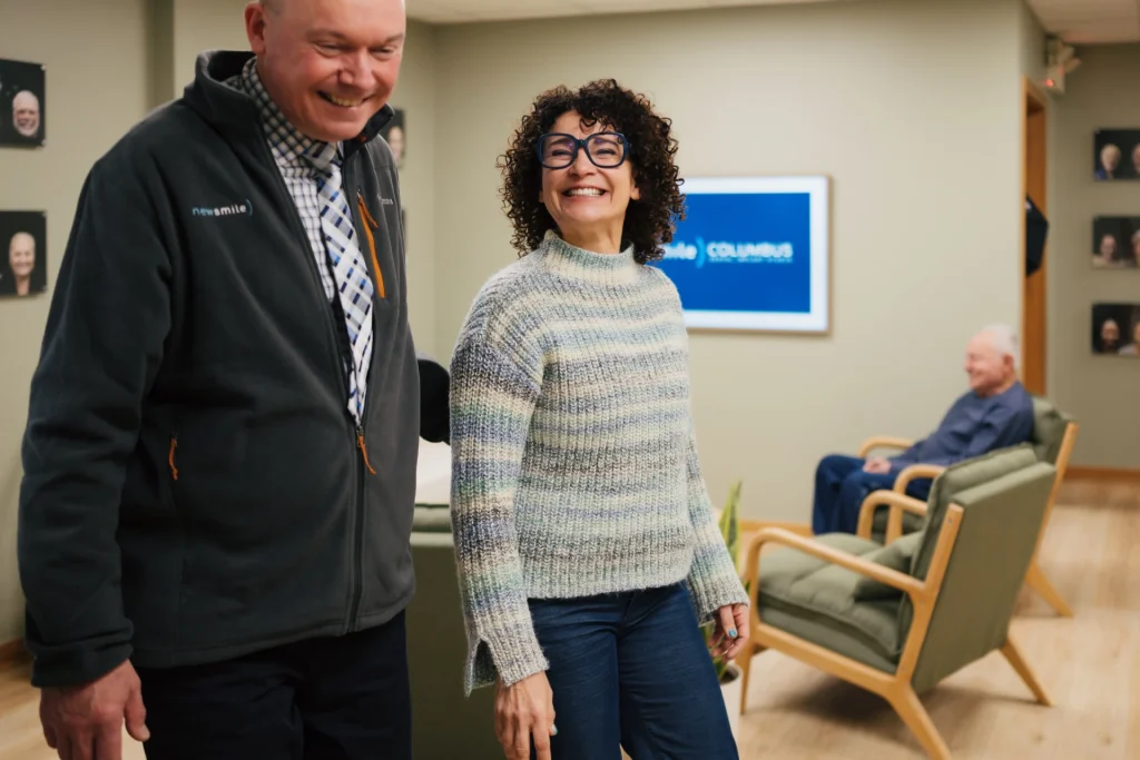 Patient showing off her final smile after full mouth dental implants at New Smile Columbus Dental Implant Studio.