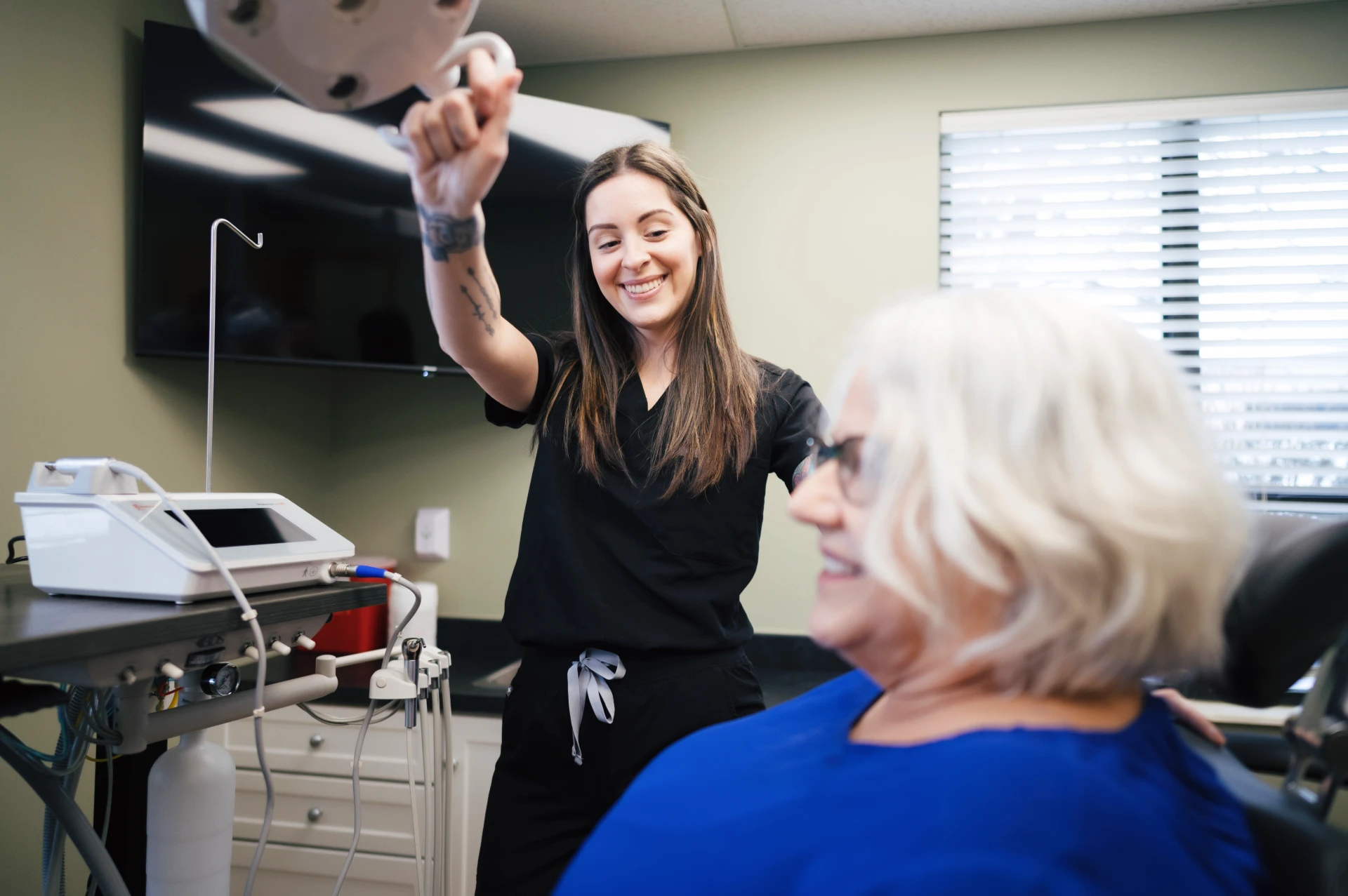 Photo of a comfortable patient in the treatment room with modern dental equipment.